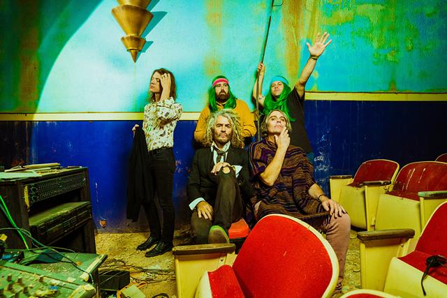 Led by frontman Wayne Coyne, seated at left, The Flaming Lips have been in the vanguard of quirky indie rock music for nearly 40 years. - PHOTO BY DEREK BROWN