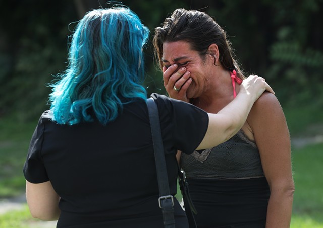 Volunteer Amy D'Amico consoles Erica, a resident of Loomis Street, who is setting out for treatment for heroin addiction. - PHOTO BY MAX SCHULTE