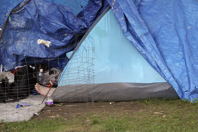 A resident of Loomis Street rests in his tent. - PHOTO BY MAX SCHULTE