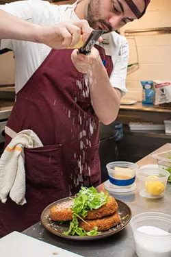 Chef Rodrigue O'Flaherty of The Revelry finishes a wild-foraged puffball mushroom cutlet with parmesan. O'Flaherty and forager Dk will co-present a Foragers Dinner in late October. - PHOTO BY JACOB WALSH