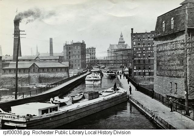The Erie Canal, looking west, circa 1897. The Aqueduct Building is on the right in the middle. Old City Hall is in the distance to the right. - ROCHESTER PUBLIC LIBRARY LOCAL HISTORY DIVISION