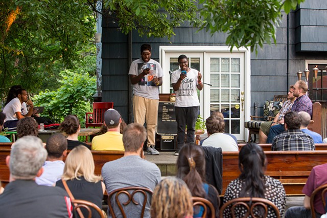Two high school students perform their works before an audience at the July 11 Poetry & Pie Night. The two young writers opened for the established poets Scott Woods and Chen Chen. - PHOTO BY JOHN SCHLIA