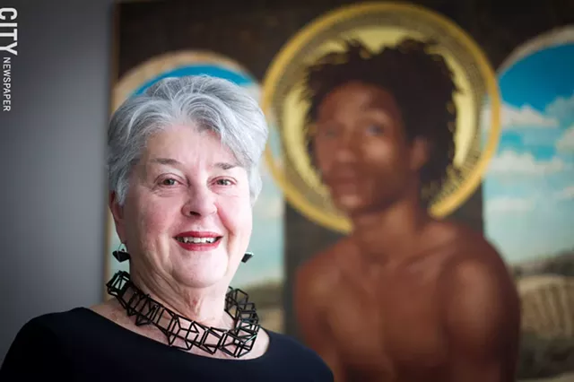 Heidi Friedrich, at home with a painting by Beth Brown, surrounds and adorns herself with art. - PHOTO BY KEVIN FULLER