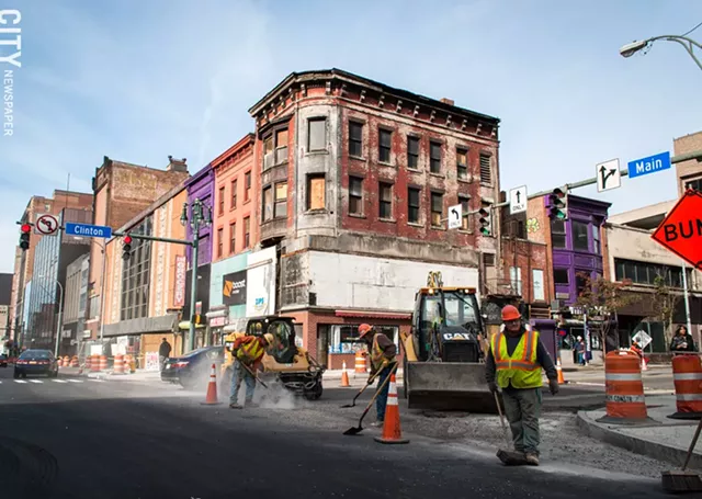 The large billboard on the top of a building at Main and Clinton has been removed, exposing its original architectural features. - PHOTO BY RYAN WILLIAMSON