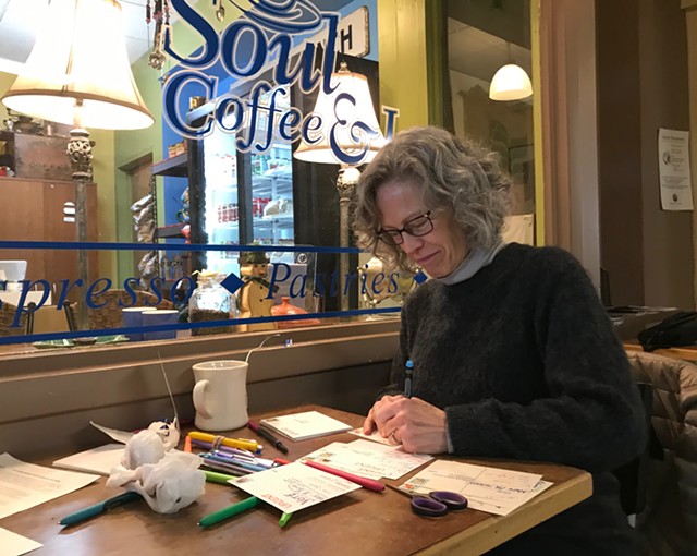 Patricia Hogenmiller, an organizer of Postcard Fridays, writes postcards at Soul Coffee and Jazz at Village Gate on Friday, January 24, 2020.