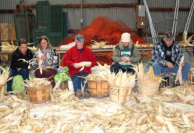 The annual Iroquois White Corn Project includes a post-harvest husking bee, during which volunteers can assist with braiding corn leaves in preparation for hanging and drying.