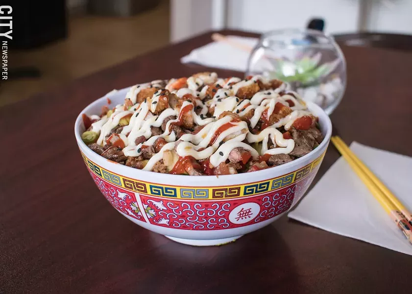 The Trasher Plate: sushi rice topped with beer-battered shrimp, grilled steak, bacon, cucumber, tomatoes, scallions, sweet bell peppers, fried garlic and onions, ponzu, ginger mayo, Sriracha, and Stingray Sauce. - PHOTO BY JACOB WALSH