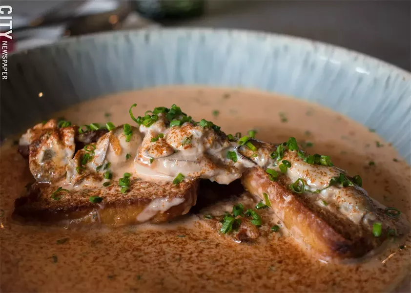 The Oyster Pan Roast: tender oysters served on top of lightly toasted bread, floating in a delightfully rich tomato cream-based sauce. - PHOTO BY JACOB WALSH