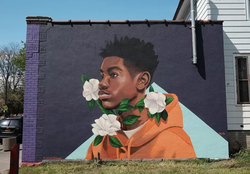 Brittany Williams' mural "Through Tragedy, There's Hope" on the side of Rocky's Pizza on Genesee Street. The piece was a collaboration between Wall\Therapy and Moms Demand Action, a national grassroots organization that pushes for public safety measures. - PHOTO BY JASON WILDER