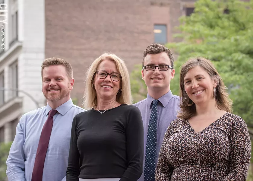 Dorraine Kirkmire, the city's manager of planning (second from the left in the photo), says the city's comprehensive plan has to strike a balance between being visionary and being realistic. In the photo, from the left, are Associate City Planner Kevin Kelley, Kirkmire, City Planner Scott Thompson, and Senior Community Planner Elizabeth Murphy. - PHOTO BY RYAN WILLIAMSON