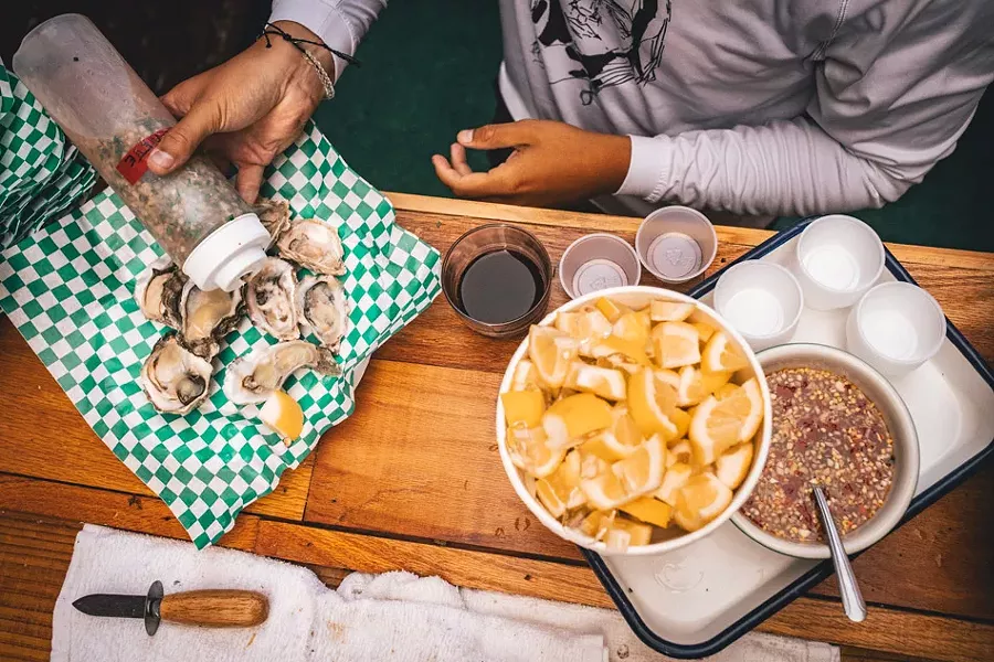 Pairings of $1 oysters and pork skewers rounded out the July wine tasting event. - PHOTO BY JASON CAMPBELL