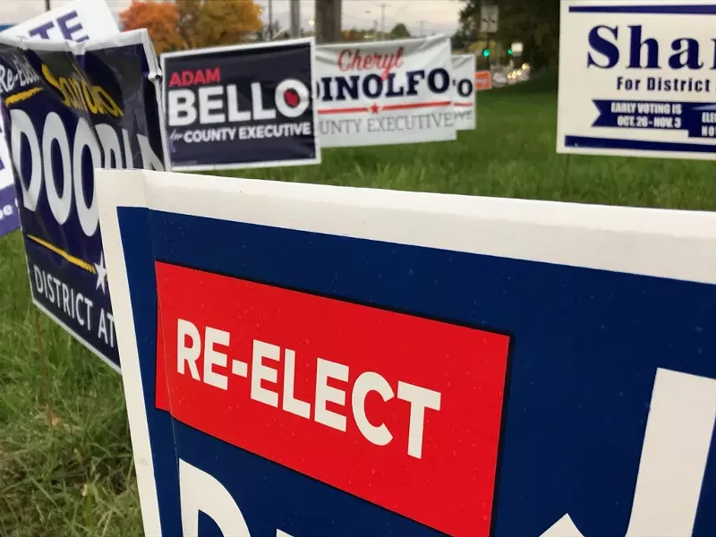 A smattering of political lawn signs crowd a street corner. - PHOTO BY DAVID ANDREATTA