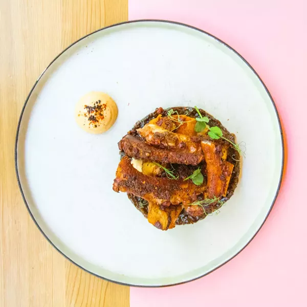 The crispy and tender roasted octopus is served with wedges of sweet potato. - PHOTO BY WILL CORNFIELD