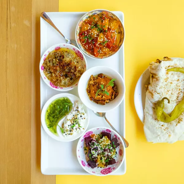 The Salatim Platter is a seasonally rotating platter of small vegetable and cheese dishes. Pictured here: Kalamata olives roasted in blood orange and chili - pepper flakes, roasted beets, fresh hummus, amba (a tangy-savory mango spread), and baba ganoush, all served with laffa bread. - PHOTO BY WILL CORNFIELD