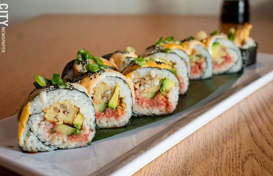 The Black Mamba includes soft shell crab, cucumber, and black tobiko, topped with eel sauce, scallions, spicy mayo, and more tobiko. - PHOTO BY JACOB WALSH