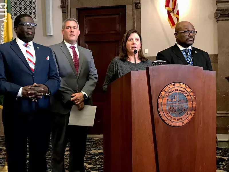 Republican Monroe County Legislator Karla Boyce, flanked by Democrats, explains her decision to vote to repeal the "police annoyance" law she sponsored months ago. Pictured with her are Democratic Minority Leader Vincent Felder, County Executive Adam Bello, and Legislator Ernest Flagler-Mitchell. - PHOTO BY DAVID ANDREATTA