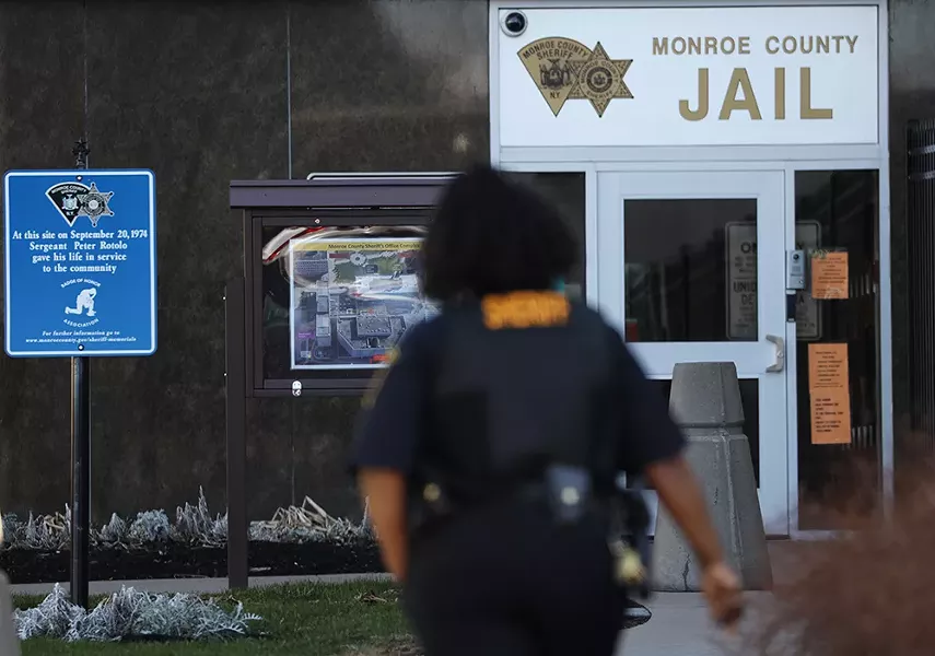 A Monroe County Sheriff's deputy outside the Monroe County Jail in downtown Rochester. - PHOTO BY MAX SCHULTE