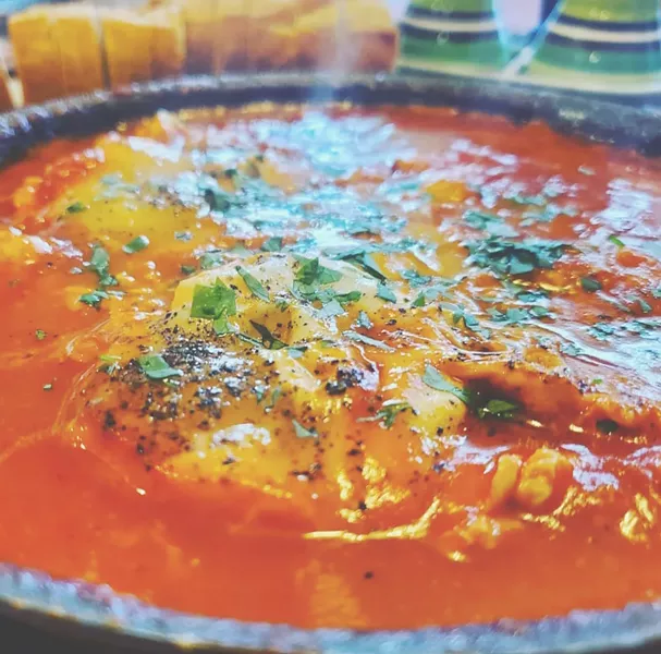 A North African and Middle Eastern classic of eggs poached in tomato sauce, Shakshuka comes in infinite combinations of spices and different cheeses. - PHOTO BY J. NEVADOMSKI
