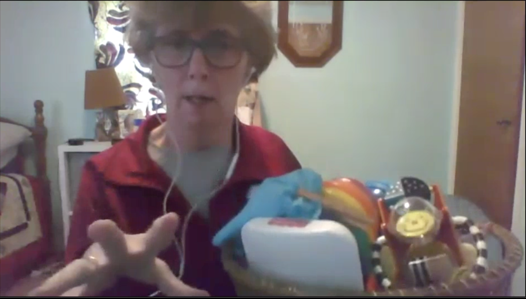 Physical therapist Janet Rosenberg holds a basket of toys that she uses in virtual early intervention therapy sessions to show caregivers how to encourage young children to move. - WXXI NEWS AND STEP BY STEP DEVELOPMENTAL SERVICES