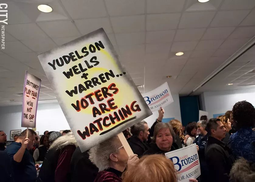 Supporters of Assembly Member Harry Bronson wave signs at the Monroe County Democratic Committee's designating convention at Workers United Hall in Rochester on Saturday, February 1, 2020. - PHOTO BY JEREMY MOULE