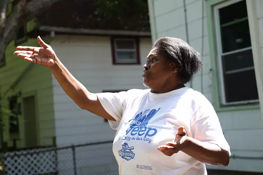 Frances Walker, stood in her Riverview Place yard and explained that the thick vegetation on the Vacuum Oil site provides cover for people up to no good. - PHOTO BY MAX SCHULTE