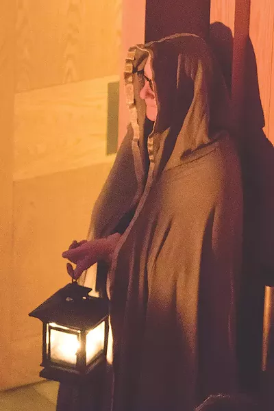The celebration of the winter solstice is focused on welcoming the light, so candles and flame are important part, as seen here from the First Unitarian Church's ceremony. - PHOTO BY DAVE BURNET