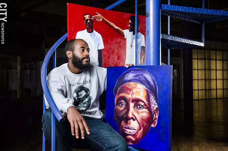 Johnnie Smith with some of his paintings. - PHOTO BY MARK CHAMBERLIN