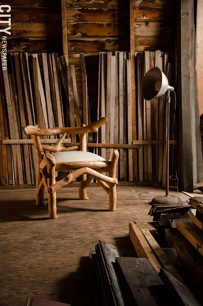 Dow creates rustic furniture from scavenged wood. - PHOTO BY MARK CHAMBERLIN