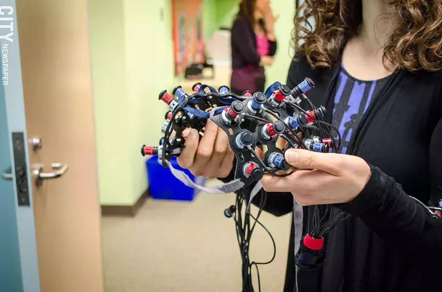 This cap beams light into the child’s head to map brain activity. - PHOTO BY MARK CHAMBERLIN