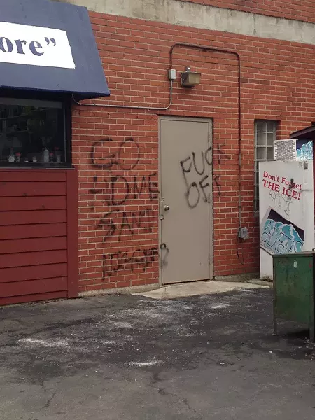 Messages spray-painted on the Corner Store include “Go home, sand niggers,” a slur directed at the Arab-Americans who operate the neighborhood business. - PHOTO BY MELODY BOYD
