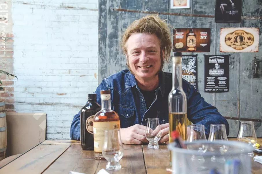 Rocker Tommy Brunett is co-owner of Fairport's Iron Smoke Whiskey. - PHOTO BY MARK CHAMBERLIN