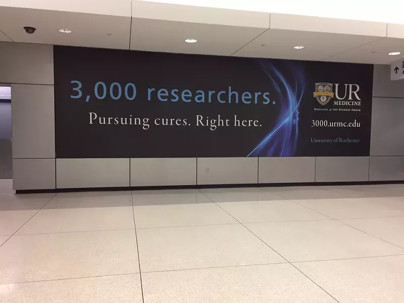 Advertising has bumped Richard Margolis' installation of photographs at the airport. - PHOTO BY MARY ANNA TOWLER