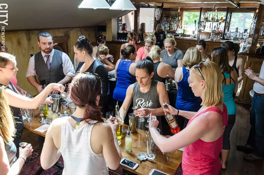 A yoga class learns about how to mix a couple of cocktails at The Daily Refresher. - PHOTO BY MARK CHAMBERLIN