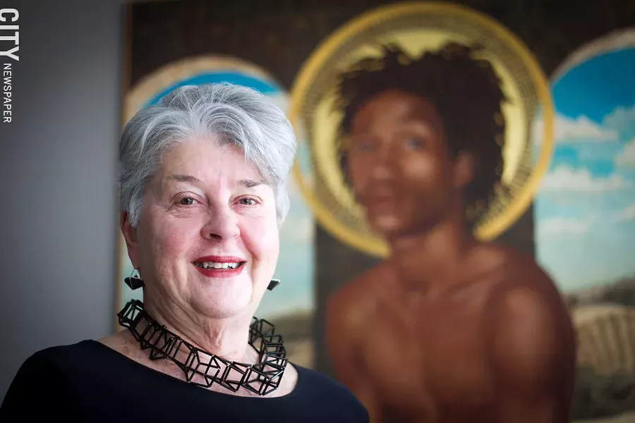 Heidi Friedrich, at home with a painting by Beth Brown, surrounds and adorns herself with art. - PHOTO BY KEVIN FULLER