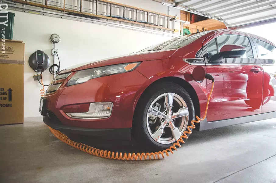 The Rochester Electric Vehicle Accelerator wants to increase the number electric vehicles and plug-in hybrids, such as this Chevrolet Volt hooked up to an at-home charger, that are on Rochester’s roads. - FILE PHOTO