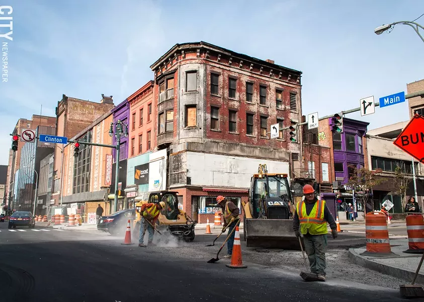 The large billboard on the top of a building at Main and Clinton has been removed, exposing its original architectural features. - PHOTO BY RYAN WILLIAMSON