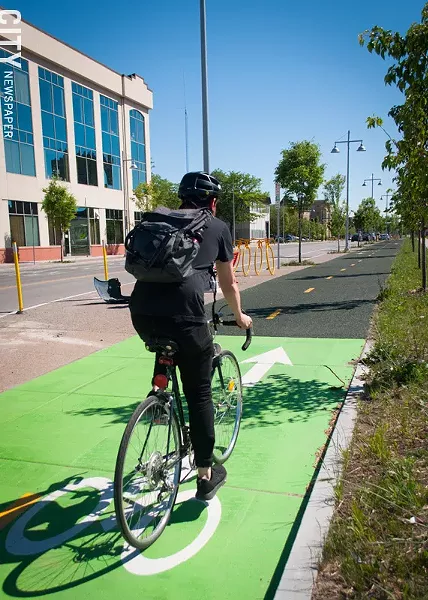 A bicyclist rides on the new cycle tracks the city built on Union Street, as part of the Inner Loop fill-in project. - PHOTO BY RENÉE HEININGER