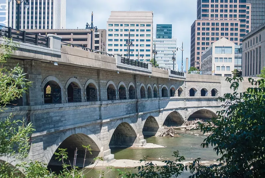 The city plans to remove the upper portion of the Broad Street bridge – the roadway and the row of arches below it – and take the bridge back to the elevation of the original Erie Canal. The bottom set of arches are the canal's original set. - FILE PHOTO