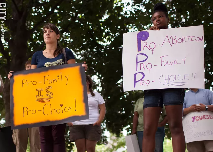Abortion rights supporters during a 2013 demonstration protesting a an anti-abortion group's annual meeting, which was held in Rochester that year. - FILE PHOTO