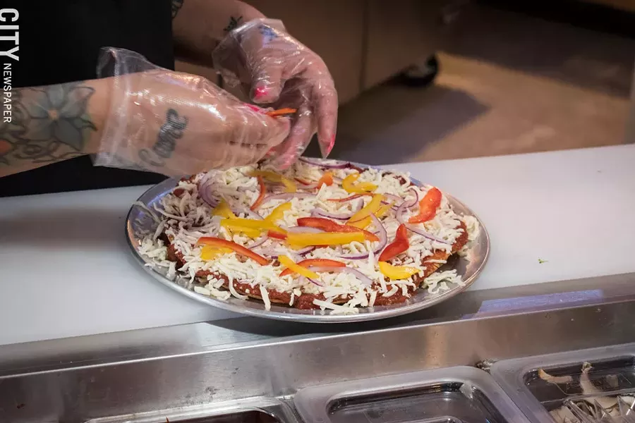 Following the fast-casual model of eateries like Chipotle, the pies at Create A Pizza are created to the customer's specifications. - PHOTO BY JACOB WALSH