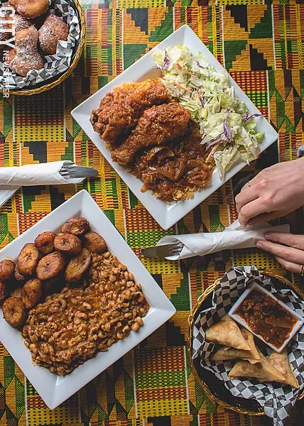 Clockwise, from bottom left: Aboboi and rice with fried plantains, jollof rice with chicken, bofrot (puff puff), and samosas at Akwaaba Restaurant. - PHOTO BY RYAN WILLIAMSON