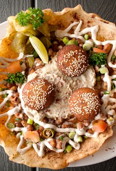 Egyptian Delight, a variety of dips and falafel in a fried pita bowl.