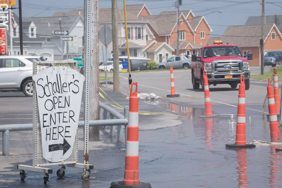 Lake Ontario flooding creeps close to the Schaller’s parking lot on Edgemere Drive in Greece. - PHOTO BY RYAN WILLIAMSON
