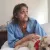 Linda Barger sits in the bed of her Sherman Street apartment with her dog, Bear. Linda Barger sits in the bed of her Sherman Street apartment with her dog, Bear.
