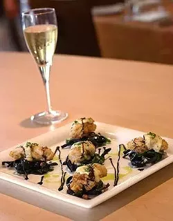 Biga on the Banks' chicken fried oysters atop squid ink linguini, Swiss chard, pancetta and mustard hollandaise.