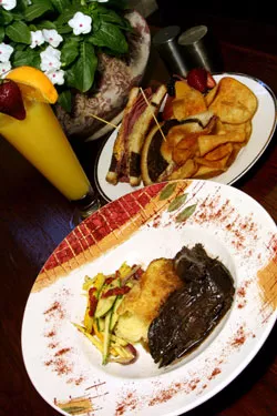 Carriage House Bistro’s red-wine demi pot roast (front) and CHB Rueben with spicy potato chips.