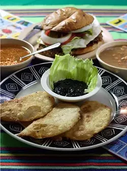 Cascabel's quesadillas de huitlacoche and a milancesa torta flanked by bowls of frijoles de la olla and sopa de fideo.