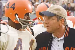 Dennis Quaid coaches Rob Brown in The Express.