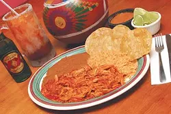 Tinga de pollo en tostadas, served hot with rice, beans, and a cold Dos Equis at Guajillo’s.