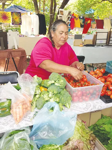 Trendy señoras hawk organic eats at open-air markets - RON BECHTOL